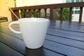 White coffee cup in the morning with soft sunlight