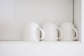 White coffee cup ob shelves