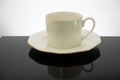 White coffee cup with plate on black table Royalty Free Stock Photo