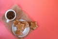 White coffee Cup and saucer on pink background with gingerbread