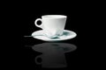 white coffee cup and saucer with spoon over black Royalty Free Stock Photo