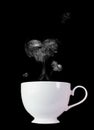 White coffee cup with white smoke, heart shape on a black background Royalty Free Stock Photo