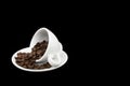 White coffee cup with spilt coffee beans Royalty Free Stock Photo