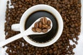 White coffee cup, spoon and roasted coffee beans that isolated on white background. top view Royalty Free Stock Photo