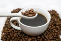 White coffee cup, spoon and roasted coffee beans that isolated on white background. top view Royalty Free Stock Photo