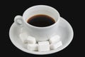White coffee cup with sugar cubes isolated on a black background Royalty Free Stock Photo