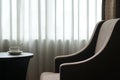 White coffee cup on the table by a sofa couch in hotel room Royalty Free Stock Photo