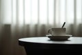 White coffee cup on the table by a sofa couch in hotel room Royalty Free Stock Photo