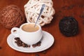 White coffee Cup with thick milk foam and spoon, closeup on wooden table. The concept of coffee break and serving coffee Royalty Free Stock Photo