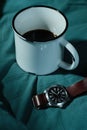 White coffee cup with watch on the bed. Morning cup up of espresso with beautiful light Royalty Free Stock Photo