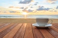 White coffee cup on wood table and view of sunset or sunrise background Royalty Free Stock Photo