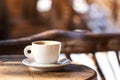 White coffee cup on wooden table. Coffee break time. Coffee shop or cafeteria background