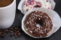 White coffee cup on a wooden table with chocolate and white chocolate donuts . Morning espresso. Morning cappuccino mug. Royalty Free Stock Photo