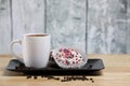 White coffee cup on a wooden table with chocolate and white chocolate donuts . Morning espresso. Morning cappuccino mug. Royalty Free Stock Photo