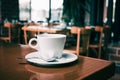 White coffee cup on wooden table in coffee shop Royalty Free Stock Photo