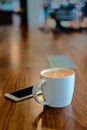 White coffee cup on wooden table on coffee shop Royalty Free Stock Photo