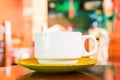 White coffee cup on wooden table. Sunny photo of morning breakfast with coffee cup. Royalty Free Stock Photo