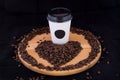 White coffee cup on a wooden tray filled with coffee beans on a Royalty Free Stock Photo