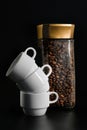 White coffee cups and a jar of coffee on a black background