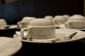 White coffee cups and saucers are placed upside down on table Royalty Free Stock Photo
