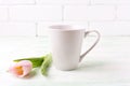 White coffee latte mug mockup with pink tulip Royalty Free Stock Photo