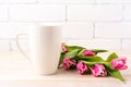 White coffee latte mug mockup with rich pink tulips bouquet Royalty Free Stock Photo