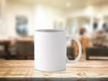White coffee mug or drink cup on blur restaurant or desserts cafe interior store background. Wooden shelf backdrops with mugs for