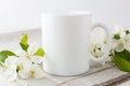 White coffee mug mockup with apple blossom