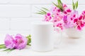 White coffee mug mockup with pink godetia flowers