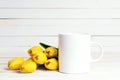 White coffee mug with yellow tulip flowers on white background Royalty Free Stock Photo