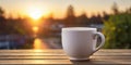 White coffee or tea mug at outdoor table during sunrise. Royalty Free Stock Photo