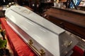 Wooden coffin covered with white acrylic in the funeral parlor