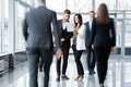 White collar workers going down office corridor during working day. Royalty Free Stock Photo