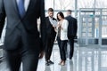 White collar workers going down office corridor during working day. Royalty Free Stock Photo