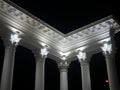 White colonnade in the dark. White columns in the light of spotlights. Street decorative architecture. Element of the