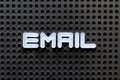 White alphabet with word e mail on black pegboard background Royalty Free Stock Photo