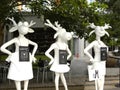 Singapore - June 1, 2009 White color art statue of three female buck deers wearing skirts