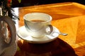 A cup of hot tea with milk on mug, put on wooden table and bright light  from sun in afternonn, Traditional english tea. Royalty Free Stock Photo