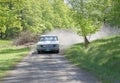 White color Ford Thunderbolt classic car from 1964 driving on a country road