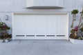 A white color garage door that fits two cars