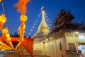 A white color of pagoda decorated by lighting at night time