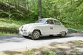 White color Saab Sport classic car from 1962 driving on a country road