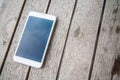 White color smartphone on woodden table Royalty Free Stock Photo