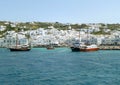 White colored Greek islands architecture on the hillside with vivid color boats at the Mykonos Old Port, Greece Royalty Free Stock Photo