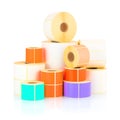 White and colored label rolls isolated on white background with shadow reflection.