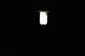 White colored glowing street lamp with black background. Idea generation and background template.