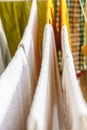 White and colored linen and towels to be dried on the clothesline