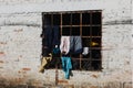 white colored window with clothes of latinos receiving the sun in colombia