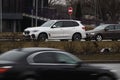 White colors SUV drive down the street in rainy weather. Heavy traffic. Motion blur. Riga, Latvia - 04 Apr 2022