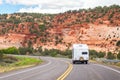 White Colour Motorhome Car Goes On Road with Background Of Mountains